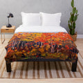 Plush blanket featuring the vibrant autumn woods artwork of Canadian painter Tom Thomson