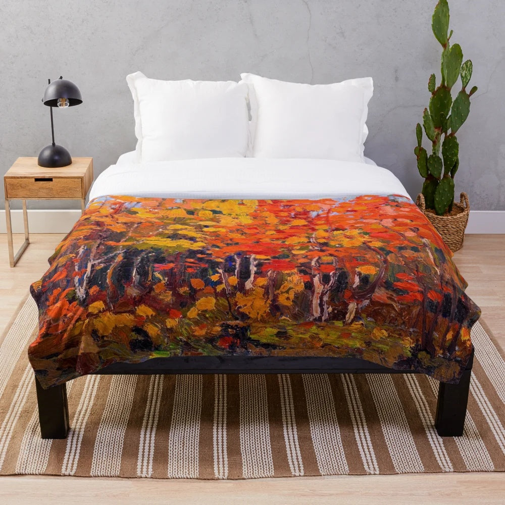 Plush blanket featuring the vibrant autumn woods artwork of Canadian painter Tom Thomson