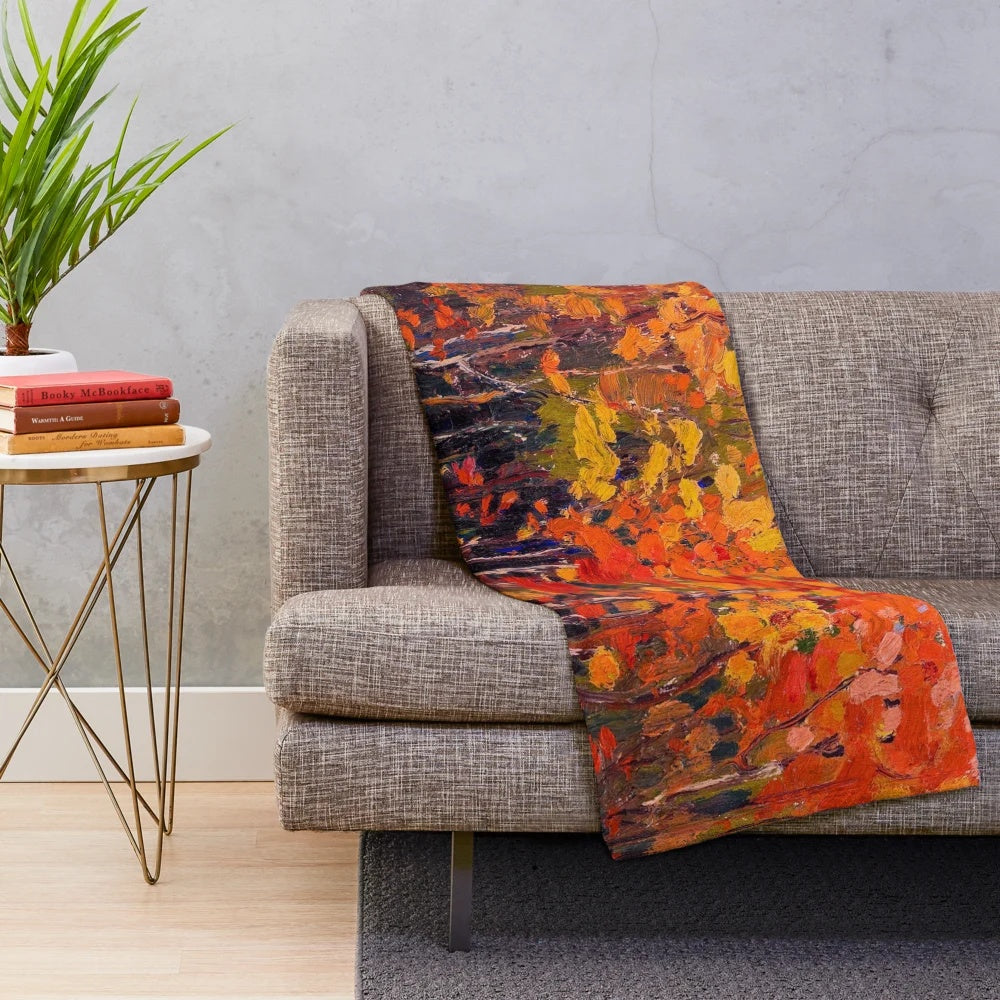 Plush blanket featuring the vibrant autumn woods artwork of Canadian painter Tom Thomson
