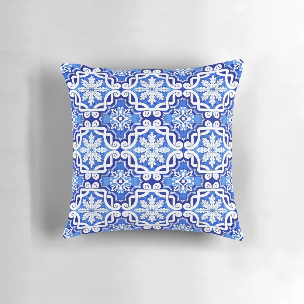 Decorative pillow featuring a watercolor painting of a traditional Portuguese azulejo tile pattern in blue and yellow.