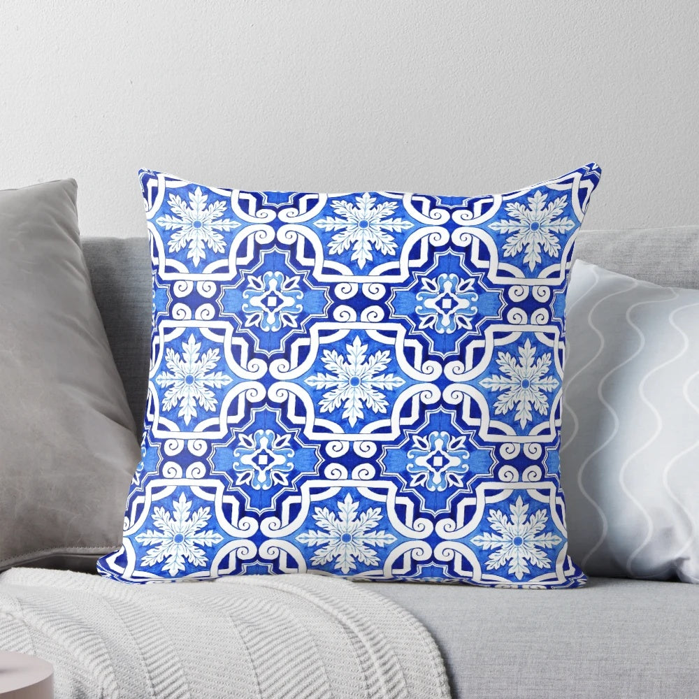 Decorative pillow featuring a watercolor painting of a traditional Portuguese azulejo tile pattern in blue and yellow.