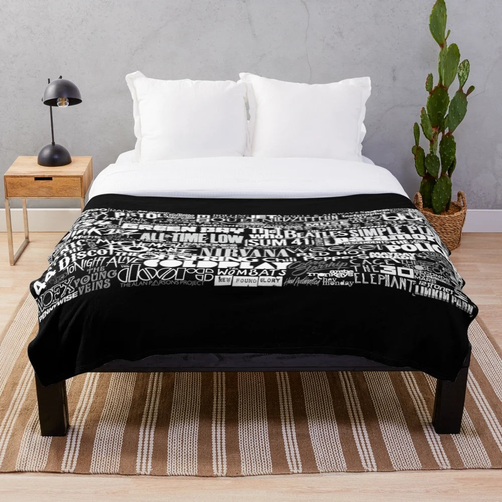 Cozy plush blanket featuring a vibrant collage of popular band imagery and lyrics