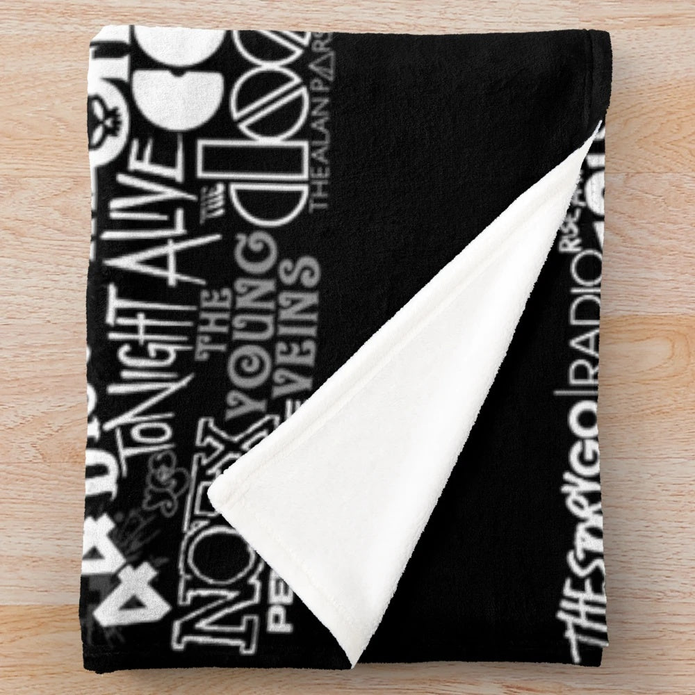 Cozy plush blanket featuring a vibrant collage of popular band imagery and lyrics