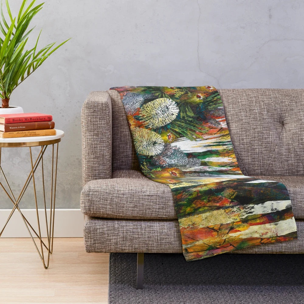 A cozy plush blanket featuring a vibrant abstract floral design inspired by Australian native flowers and plants.