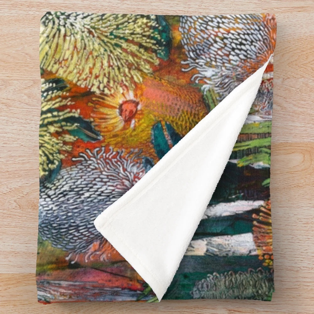 A cozy plush blanket featuring a vibrant abstract floral design inspired by Australian native flowers and plants.