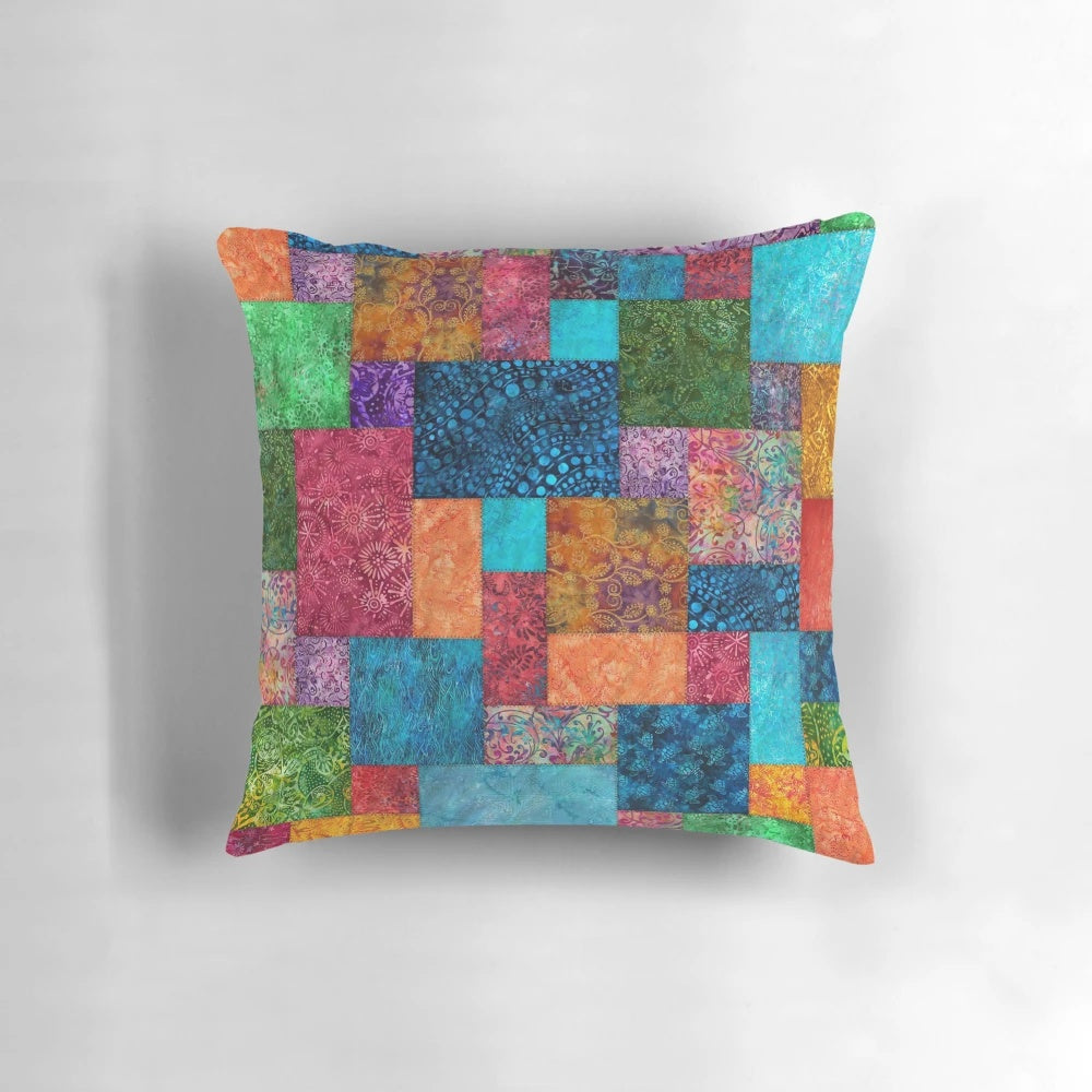 Colorful batik patchwork quilted pillow with bohemian, boho, and hippie design elements.