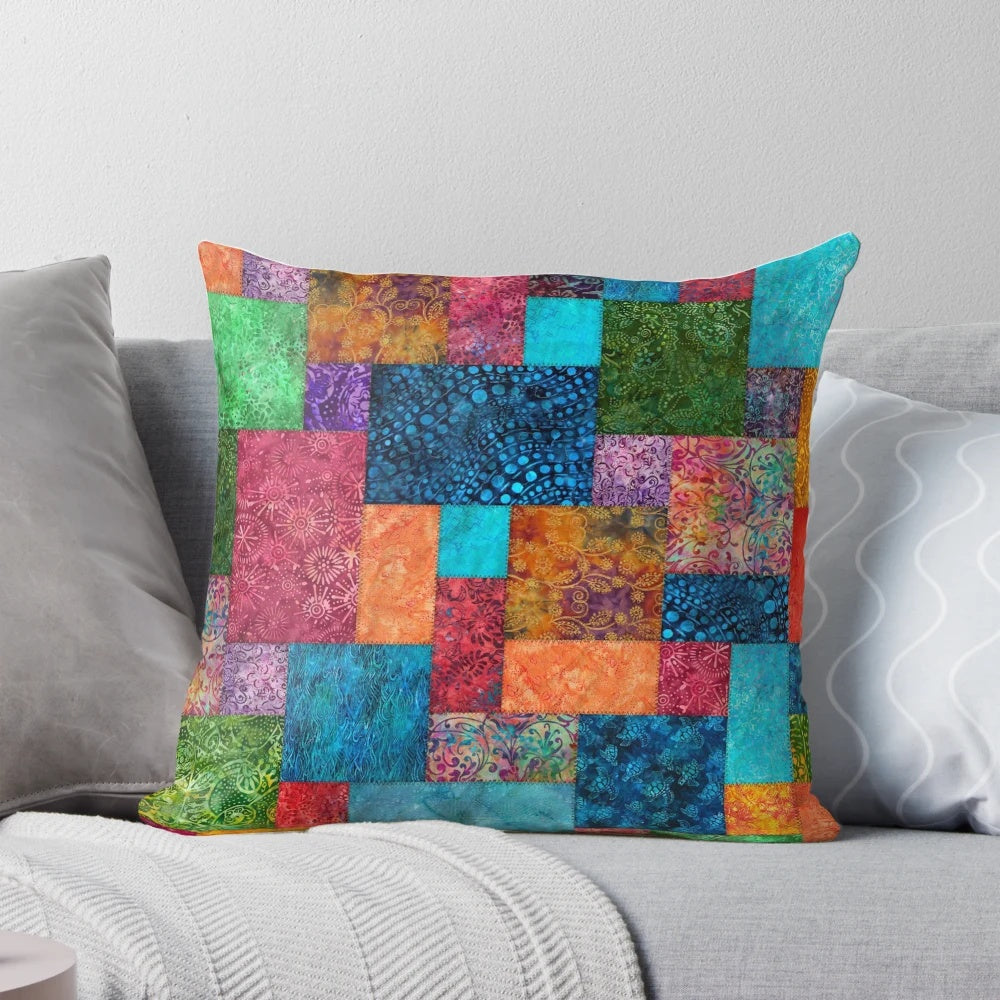 Colorful batik patchwork quilted pillow with bohemian, boho, and hippie design elements.
