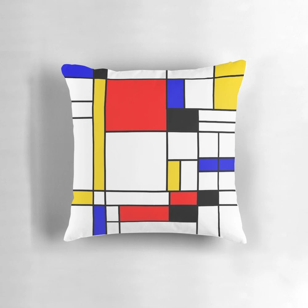 Colorful square and rectangle patterned pillow with blue, red, yellow, black, and white geometric design inspired by Bauhaus and Mondrian styles.