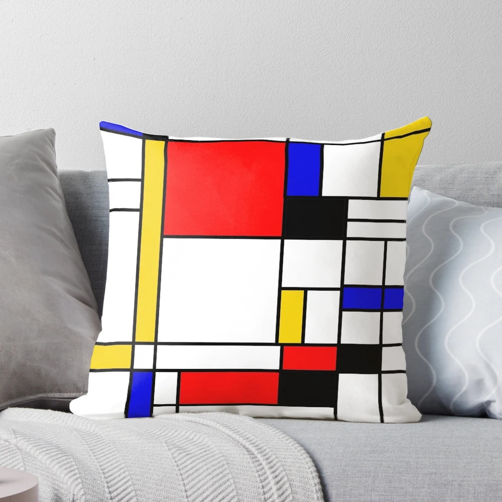 Colorful square and rectangle patterned pillow with blue, red, yellow, black, and white geometric design inspired by Bauhaus and Mondrian styles.