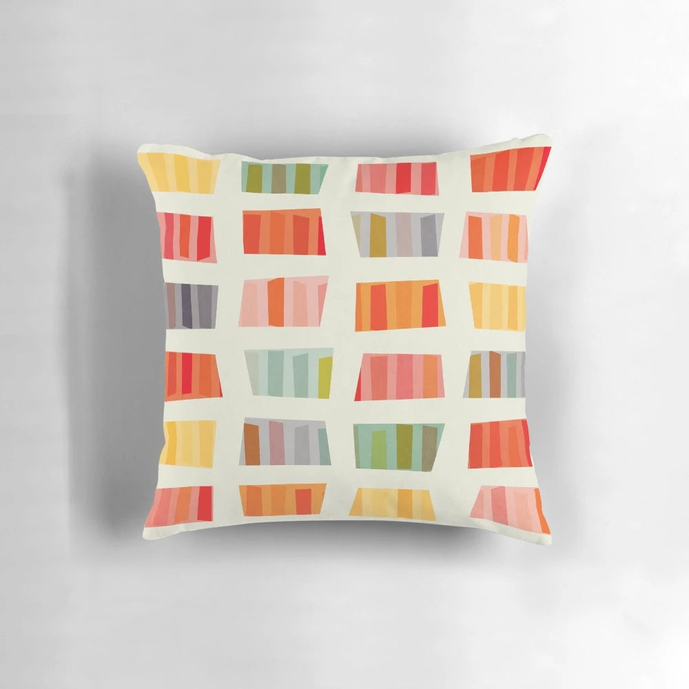 Colorful and abstract beach towel pattern printed on a soft pillow for a cozy vacation vibe