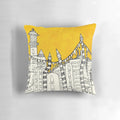 Colorful abstract throw pillow with a design featuring a big yellow sun over a small city skyline.