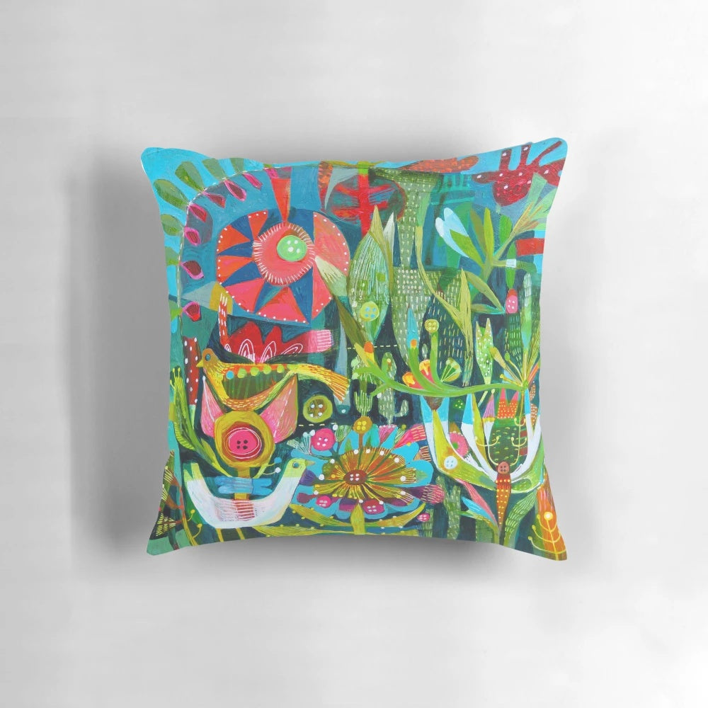 Colorful throw pillow with a vibrant design featuring birds, flowers, and a garden-inspired pattern.