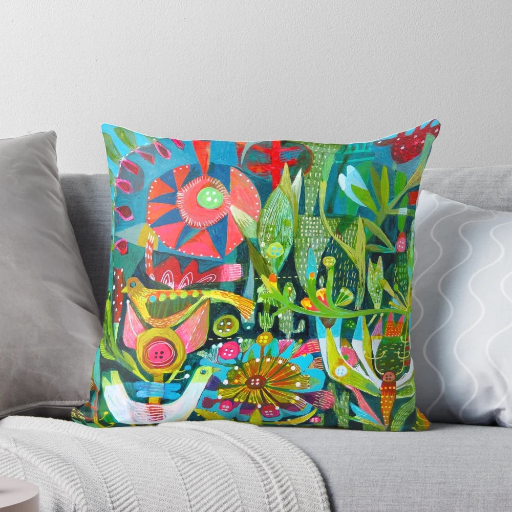 Colorful throw pillow with a vibrant design featuring birds, flowers, and a garden-inspired pattern.