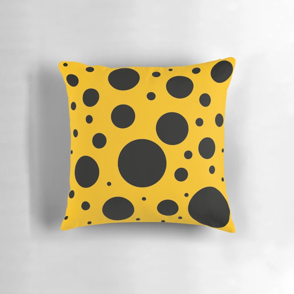 Stylish black and yellow polka dot pattern on a modern, minimalist throw pillow