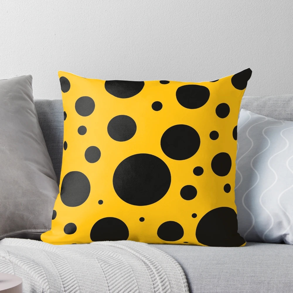 Stylish black and yellow polka dot pattern on a modern, minimalist throw pillow