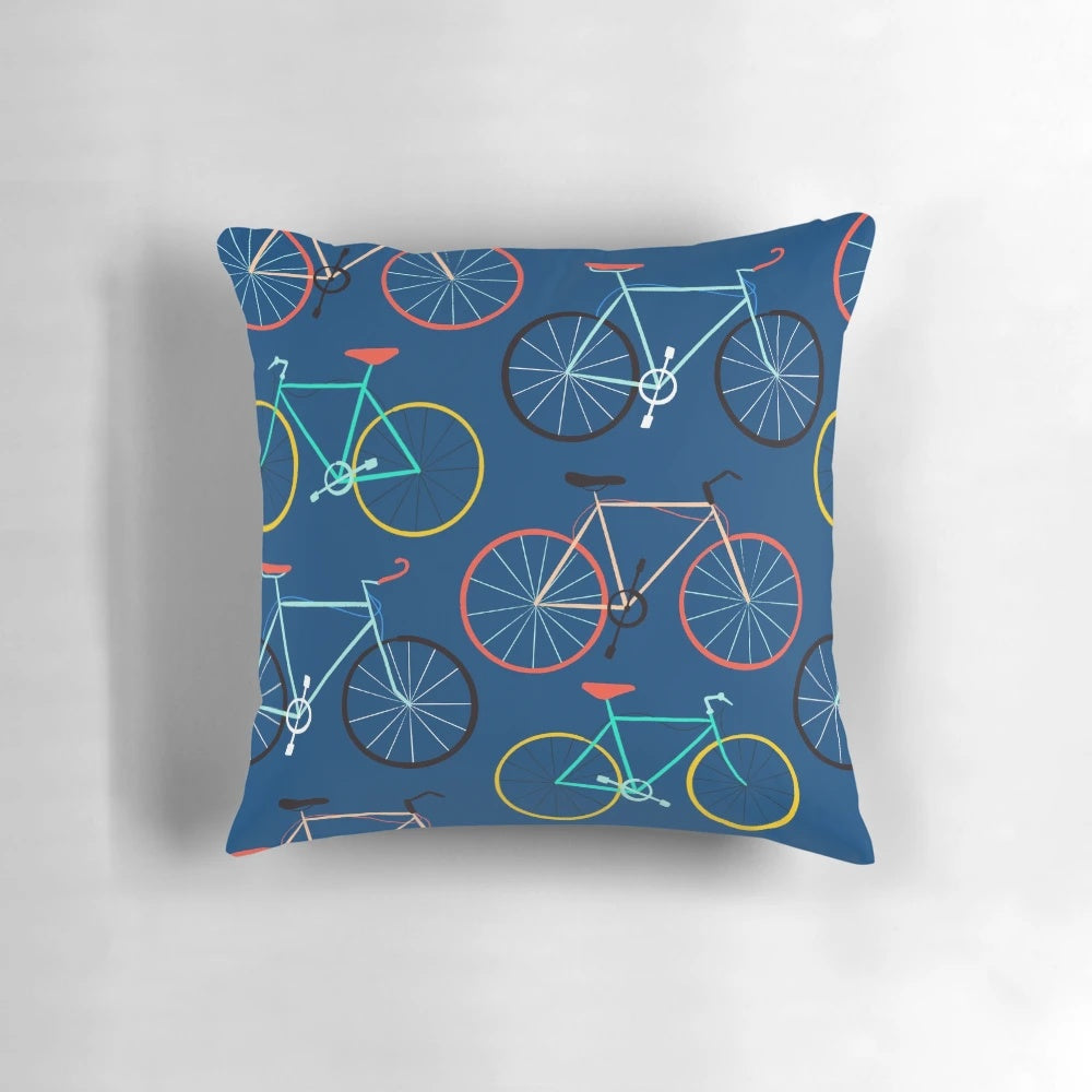 A colorful blue pillow featuring a bicycle design, perfect for cyclists and fitness enthusiasts.