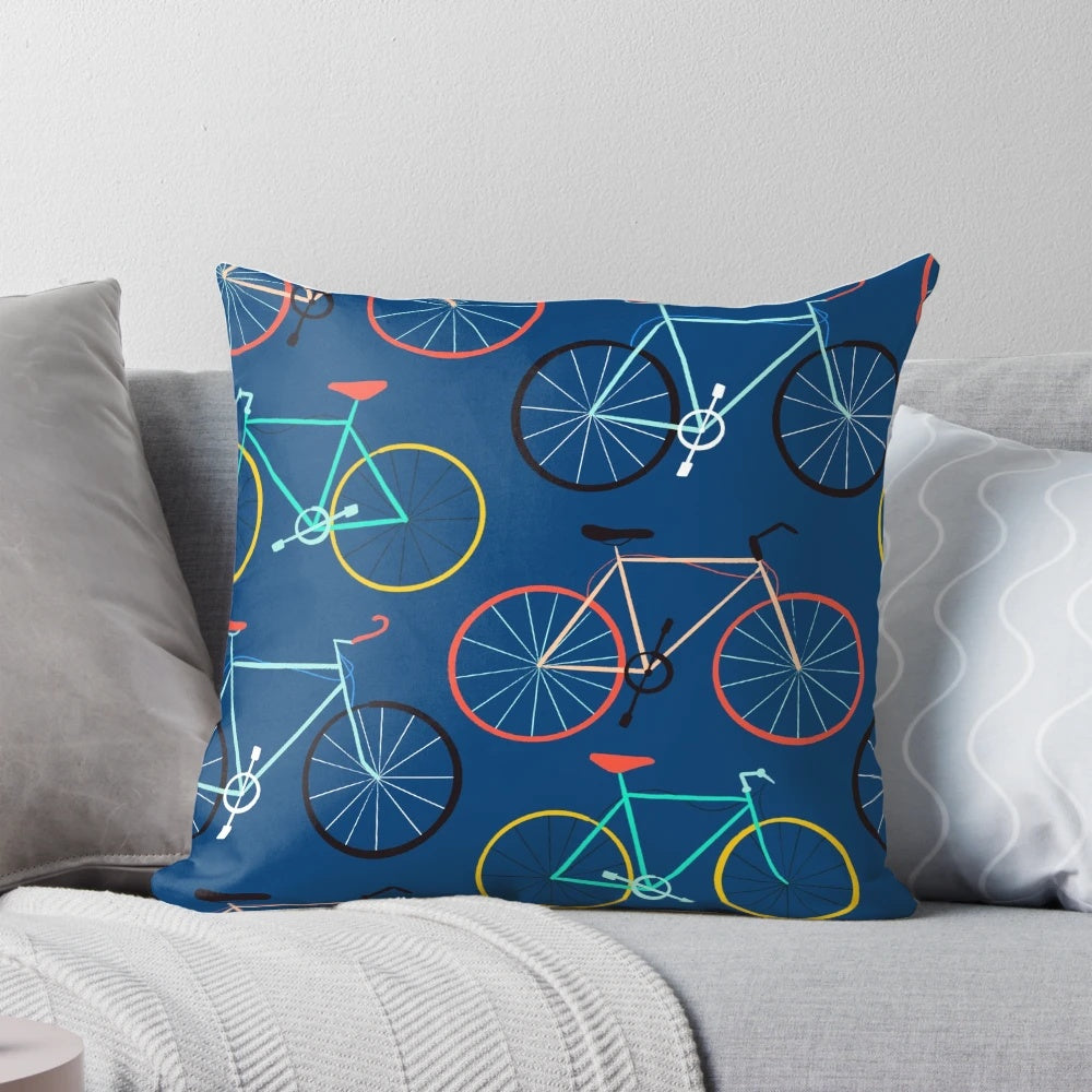 A colorful blue pillow featuring a bicycle design, perfect for cyclists and fitness enthusiasts.