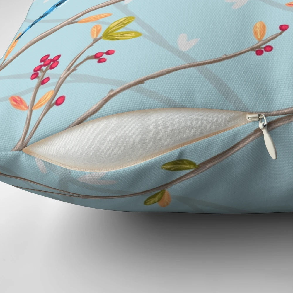 A colorful throw pillow featuring a seamless pattern of blue jays and red cardinals perched on tree twigs.