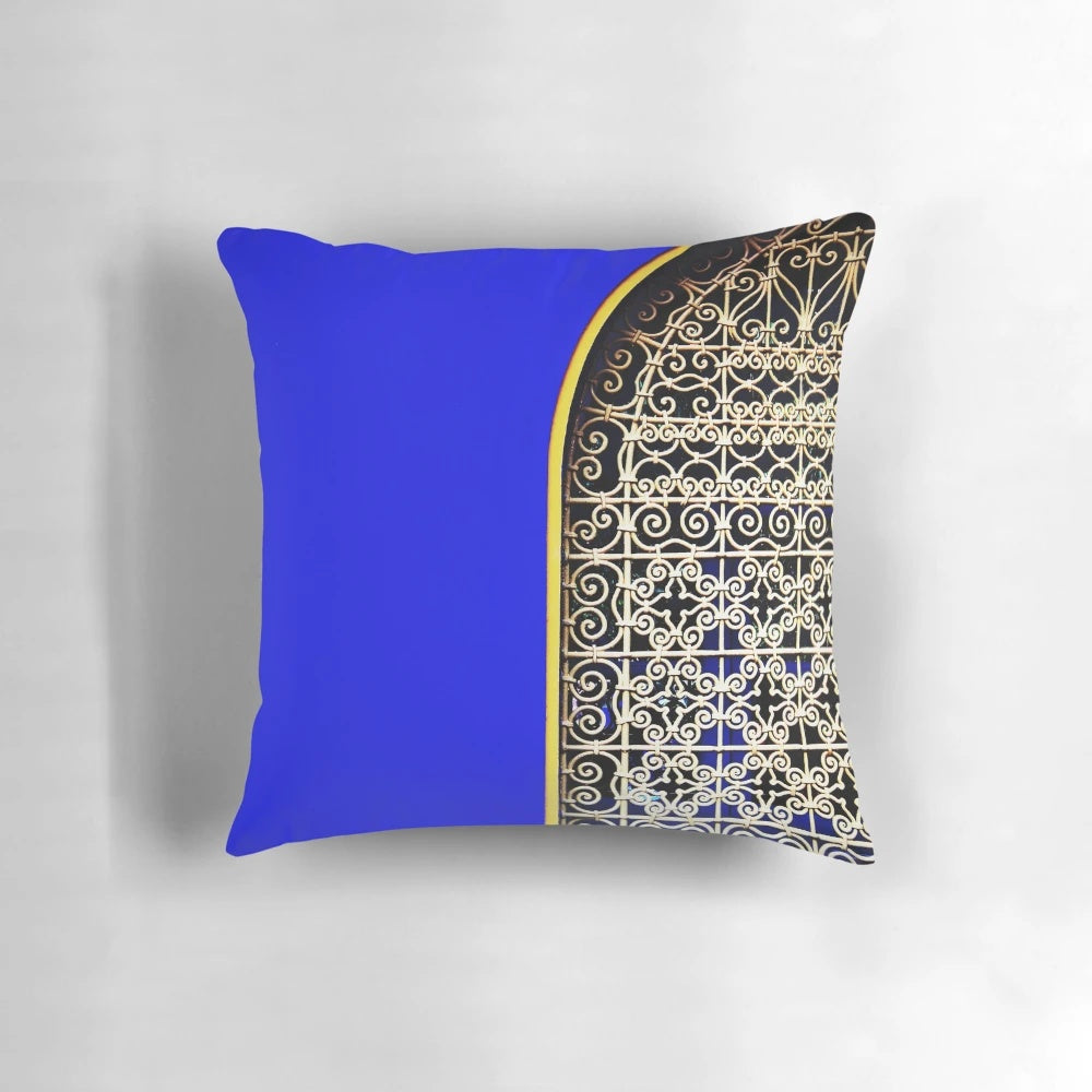 Closeup of a luxurious blue Majorelle pillow with a tropical, lush design