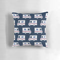 Closeup of a blue pillow with a mail truck and little arrow design printed on it