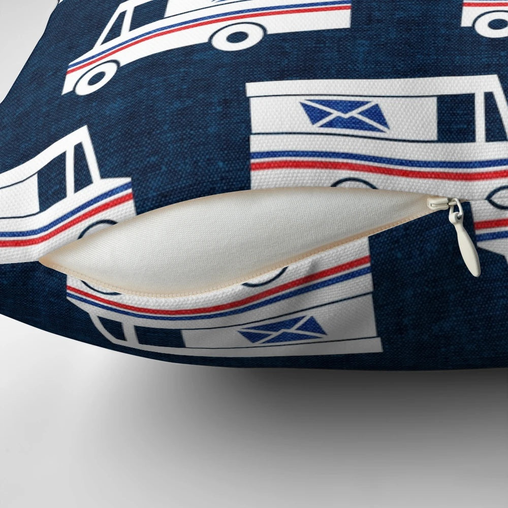 Closeup of a blue pillow with a mail truck and little arrow design printed on it