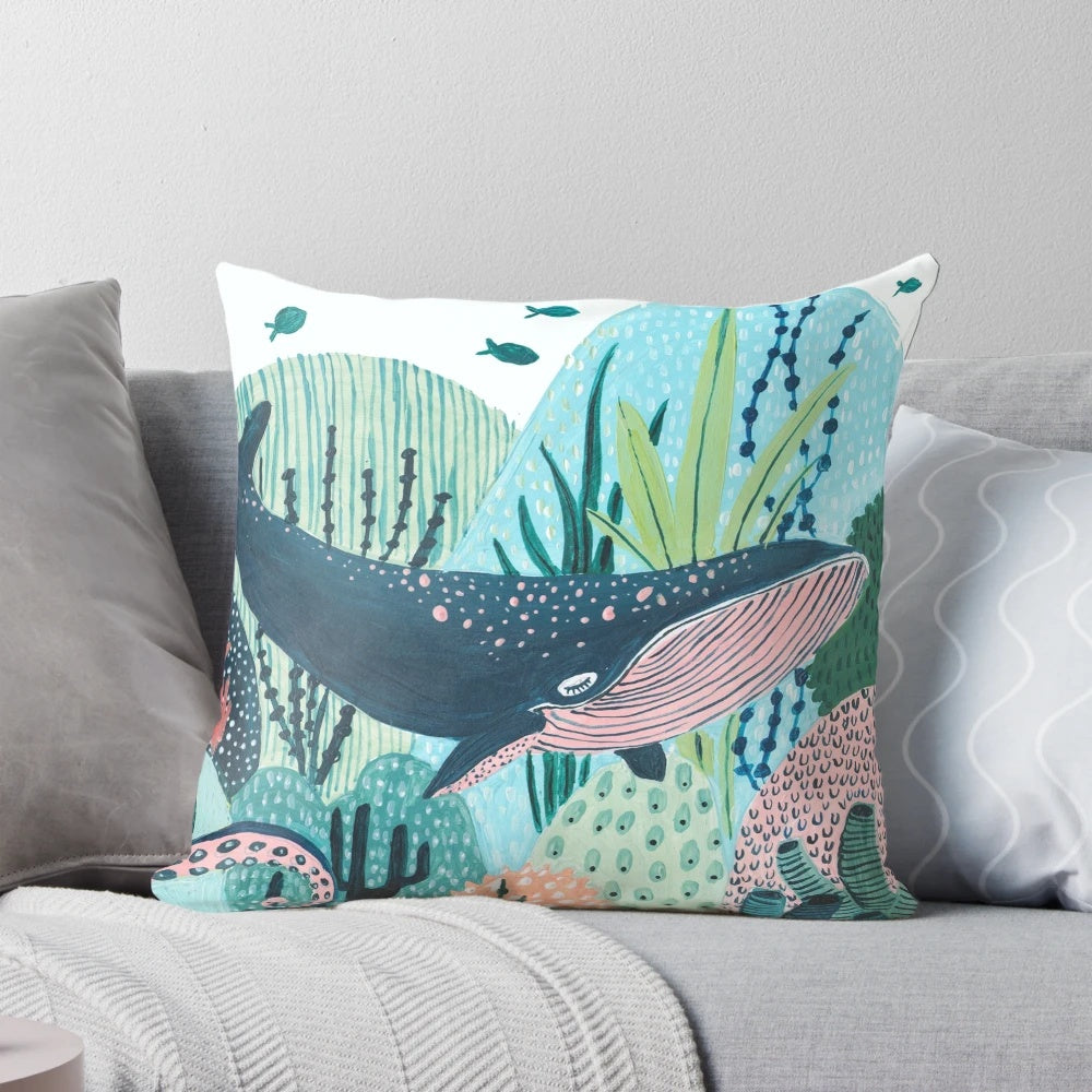 Decorative blue whale pillow with coral, tentacles, and ocean creatures for a whimsical nursery