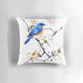 Vibrant watercolor painting of a bluebird perched on a dogwood branch with spring flowers