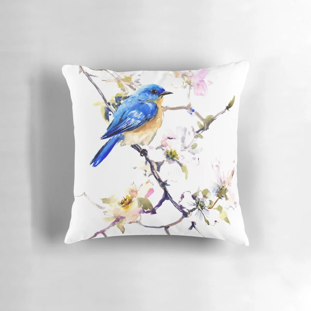 Vibrant watercolor painting of a bluebird perched on a dogwood branch with spring flowers