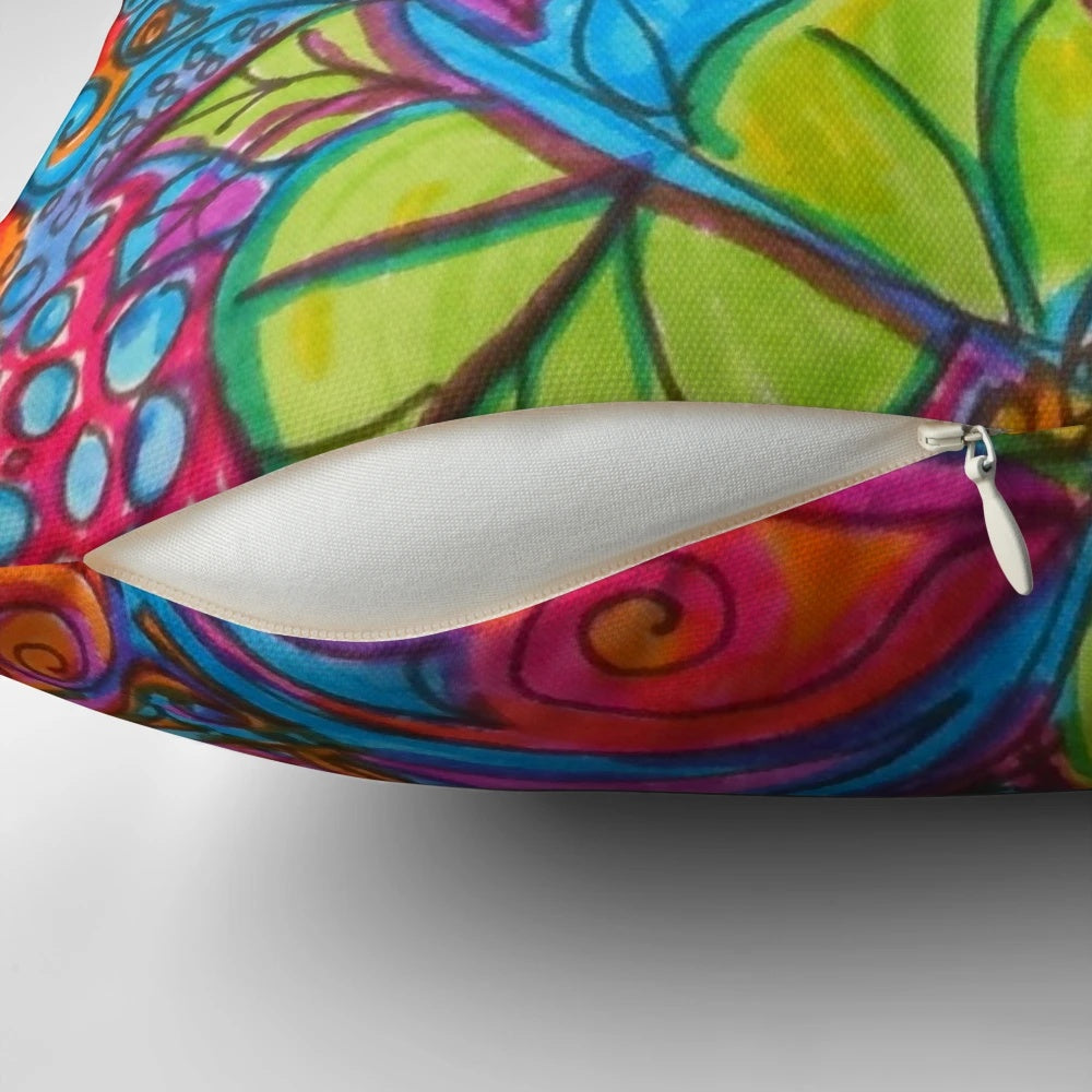 Colorful abstract art pillow with doodles, flowers, and hearts in a bohemian style