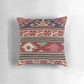 Colorful bohemian-inspired throw pillow with abstract Aztec pattern and retro sunburst design