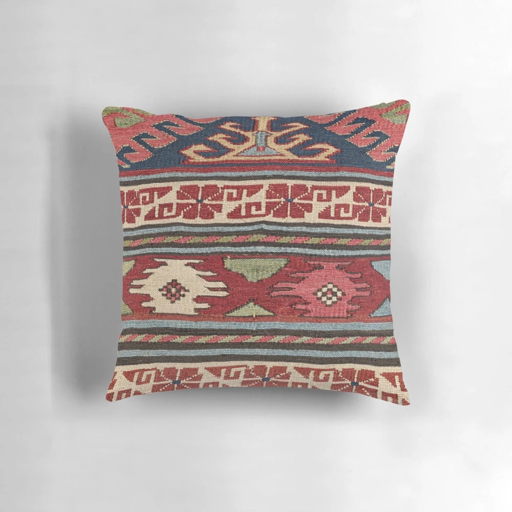 Colorful bohemian-inspired throw pillow with abstract Aztec pattern and retro sunburst design