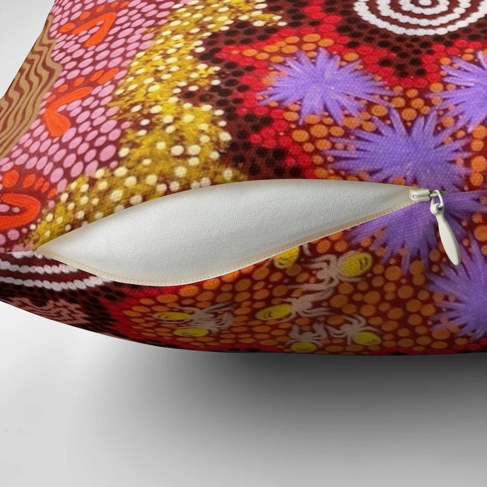 Pillow featuring a vibrant abstract design inspired by Australian aboriginal dot painting art