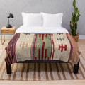Colorful boho-inspired plush blanket with abstract, southwestern-style pattern