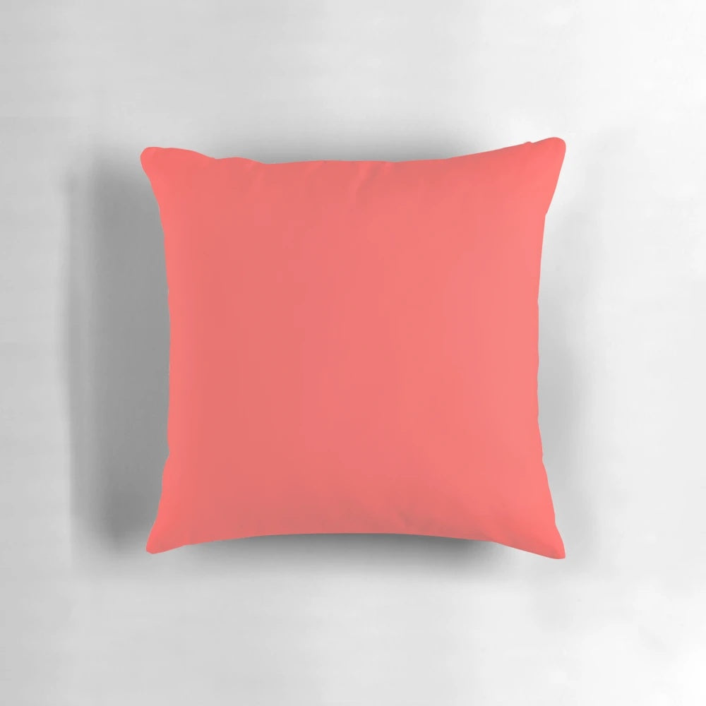Bright coral-colored pillow with a modern, minimalist design for stylish home decor.
