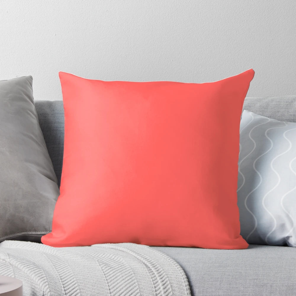 Bright coral-colored pillow with a modern, minimalist design for stylish home decor.