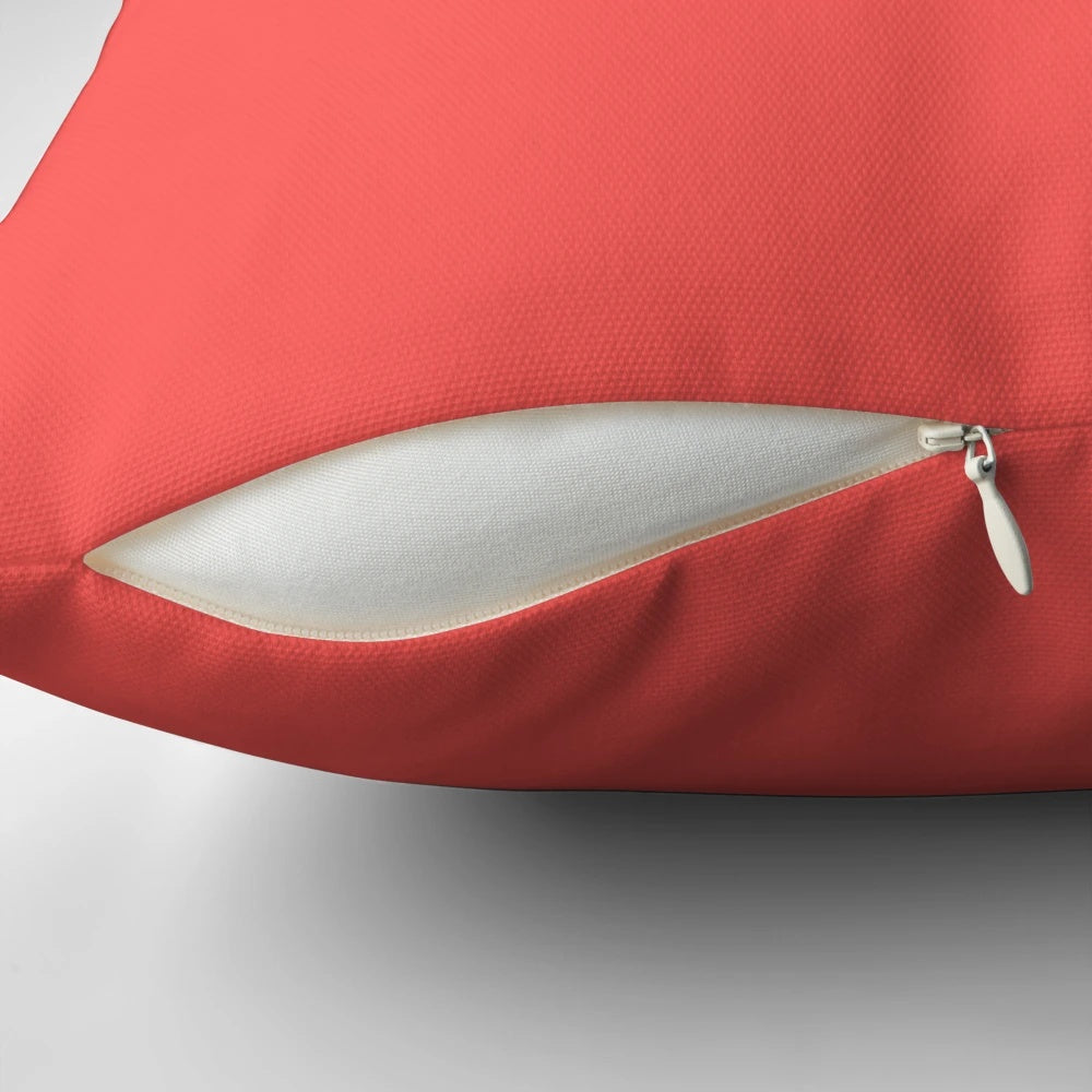 Bright coral-colored pillow with a modern, minimalist design for stylish home decor.