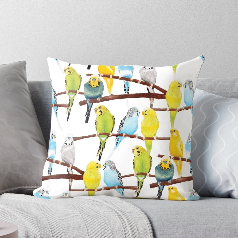 Soft, decorative pillow featuring a vibrant watercolor pattern of budgies in shades of yellow, blue, green, and grey.