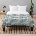 Colorful budgies (Australian parrots) sitting on a branch in a watercolor painting design on a plush blanket
