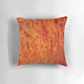 Burnt orange decorative pillow with textured abstract design