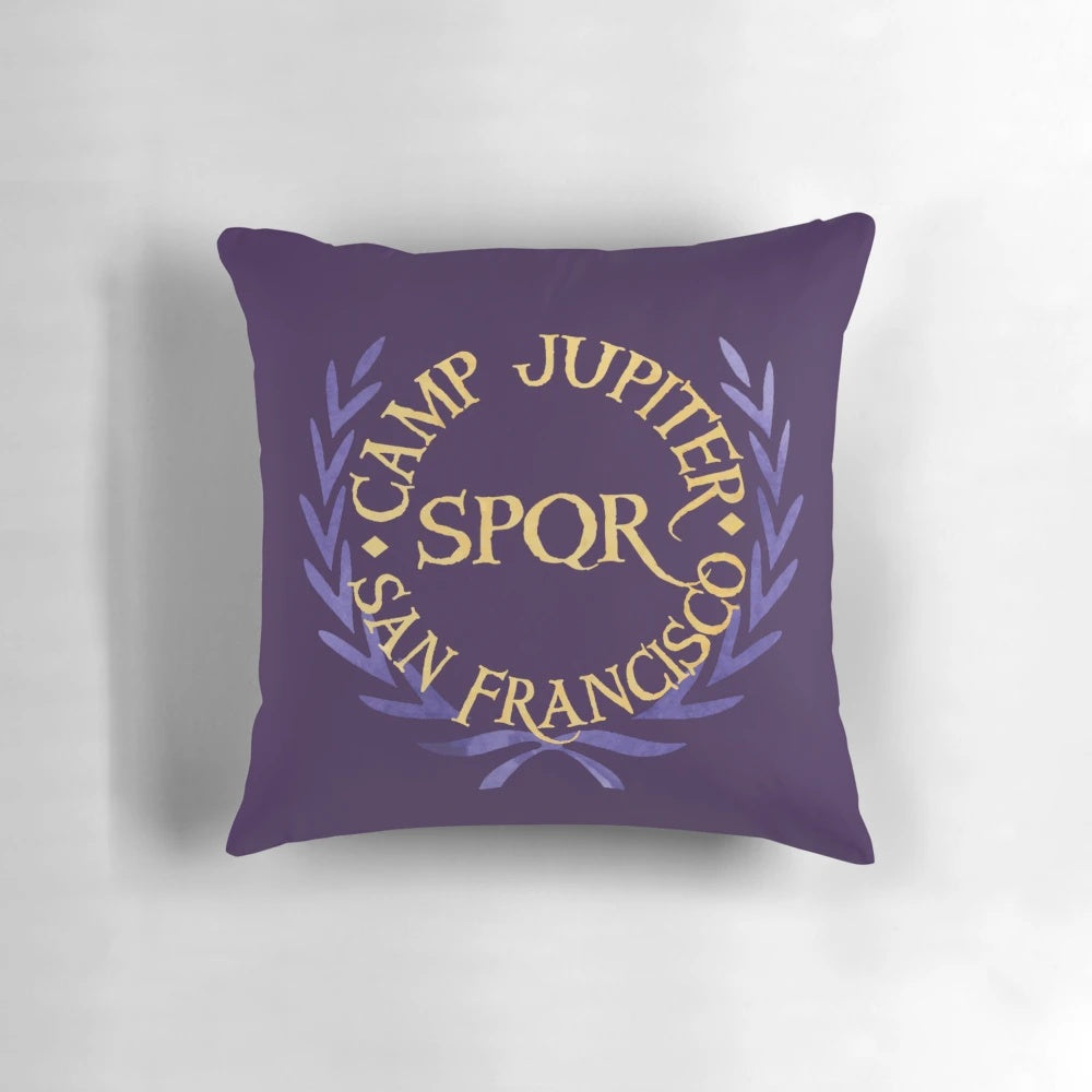 Colorful watercolor-style camp jupiter pillow featuring the logo from the Percy Jackson book series