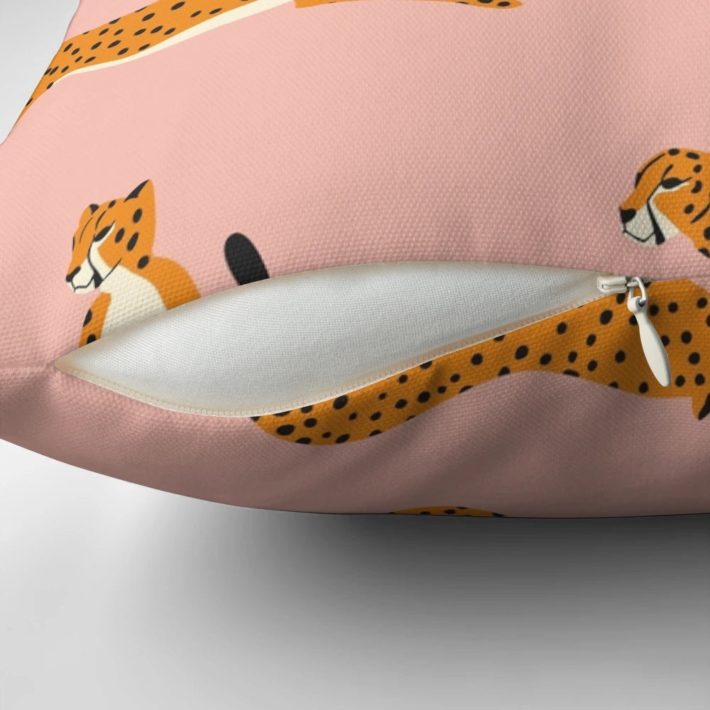 Closeup view of a pink and white cheetah pattern printed on a decorative throw pillow.