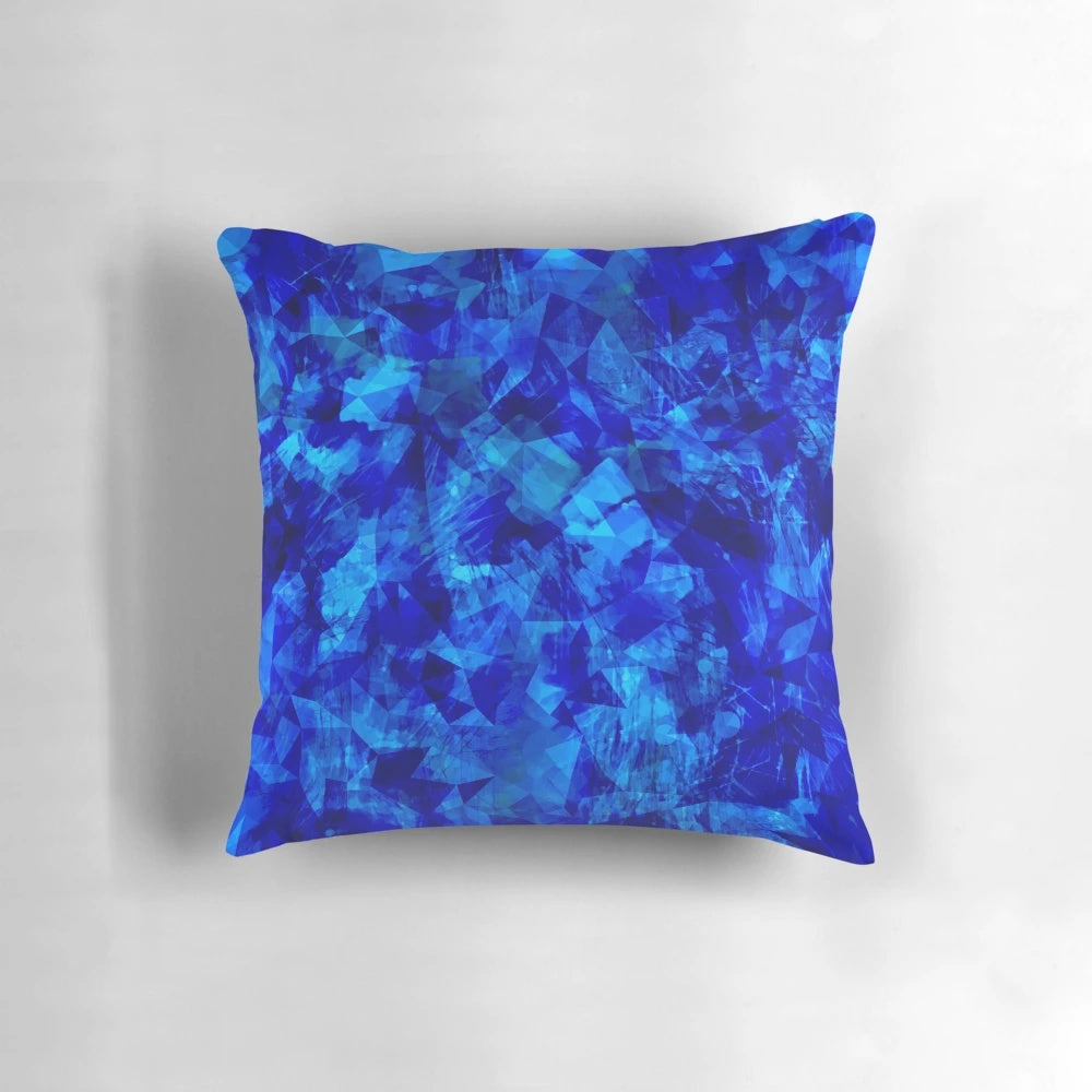 Cobalt blue and black geometric faceted pillow with abstract circle and shape pattern