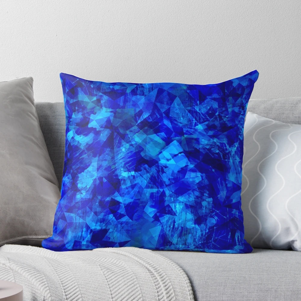 Cobalt blue and black geometric faceted pillow with abstract circle and shape pattern