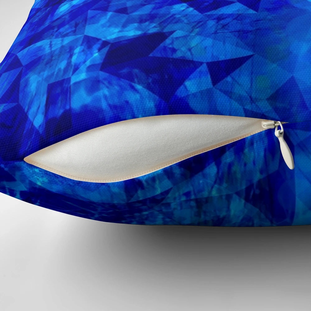 Cobalt blue and black geometric faceted pillow with abstract circle and shape pattern