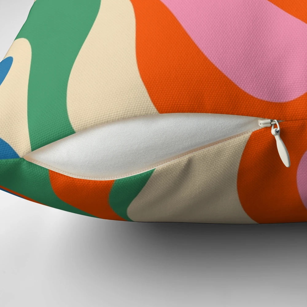 Vibrant, colorful abstract pattern on a modern throw pillow with a retro, psychedelic design.