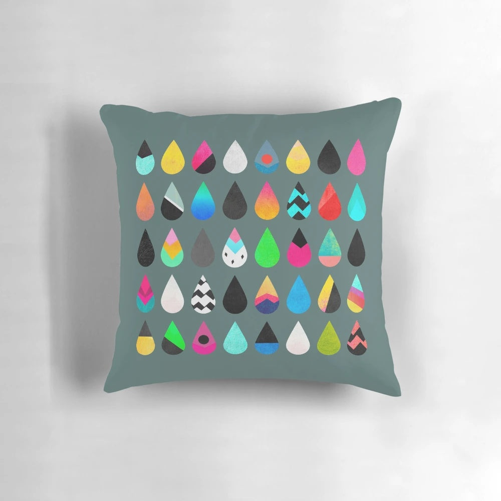 Colorful rain pillow with abstract graphic and multicolored droplet design