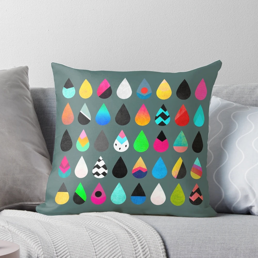 Colorful rain pillow with abstract graphic and multicolored droplet design