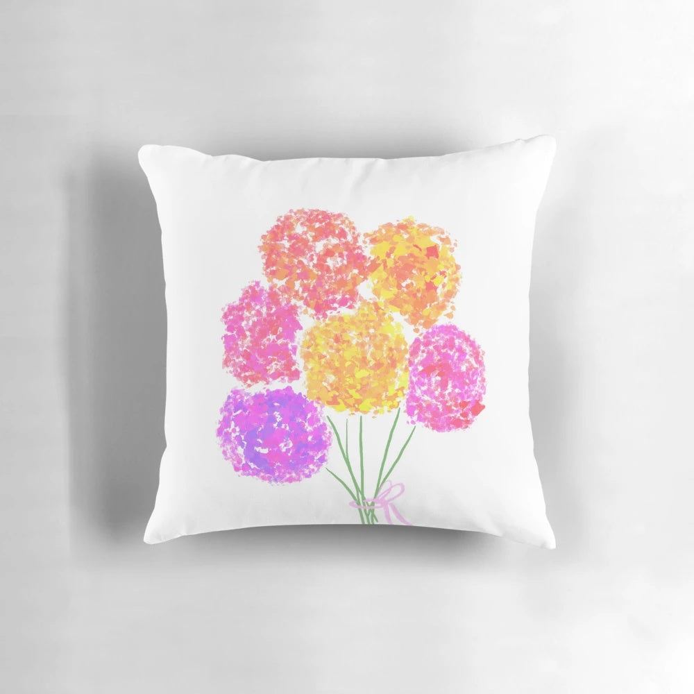 A vibrant and colorful flower bouquet pillow featuring a coquette aesthetic with a pink bow.