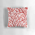 Red and gold watercolor coral design on a decorative throw pillow