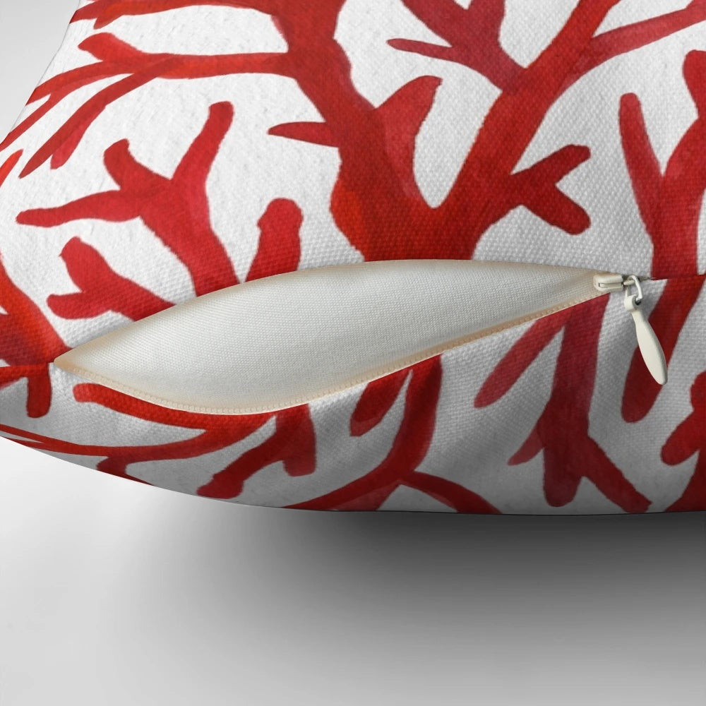 Red and gold watercolor coral design on a decorative throw pillow